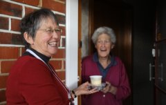 A Meals on Wheels Volunteer delivering a hot meal to a recipient
