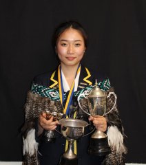 A photo of Yilin holding her Year 13 awards